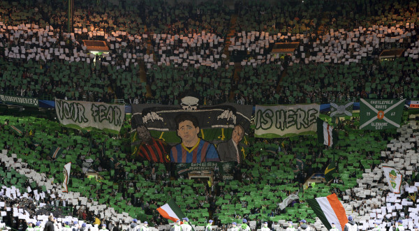 Celtic supporters hold up banners before their Champions League soccer match against Barcelona at Celtic Park in Glasgow